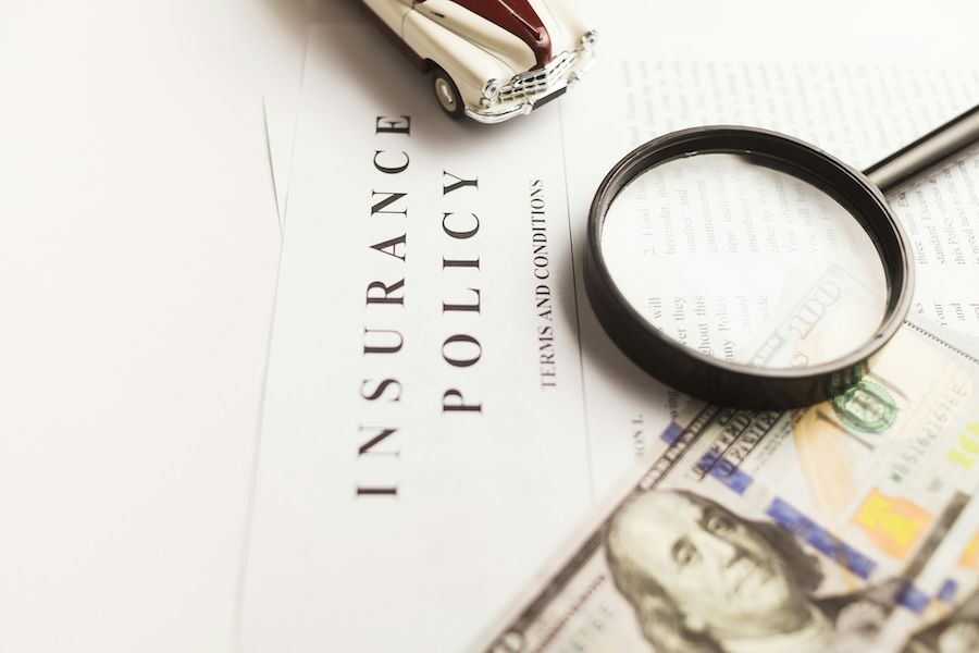Magnifying glass on an insurance policy document