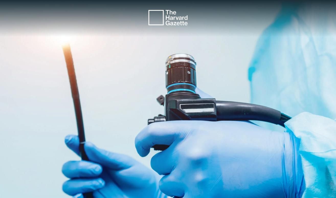 Doctor holding endoscope.